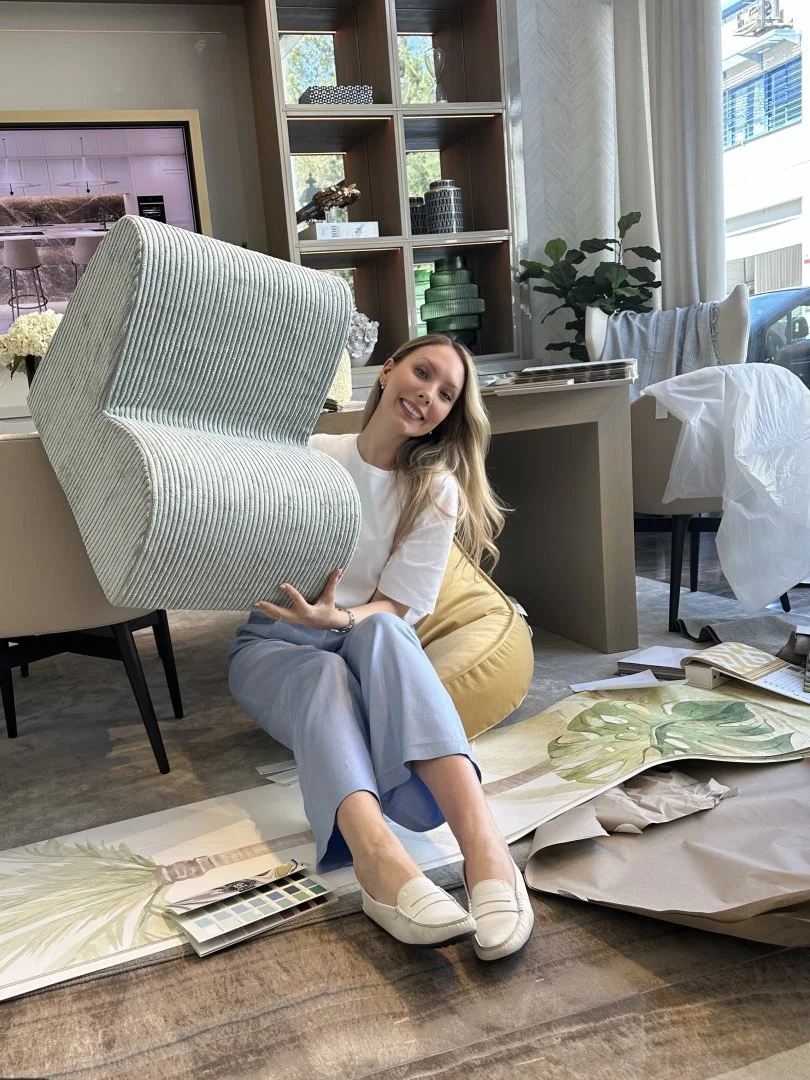 Designer showcasing a textured striped chair in a styled space